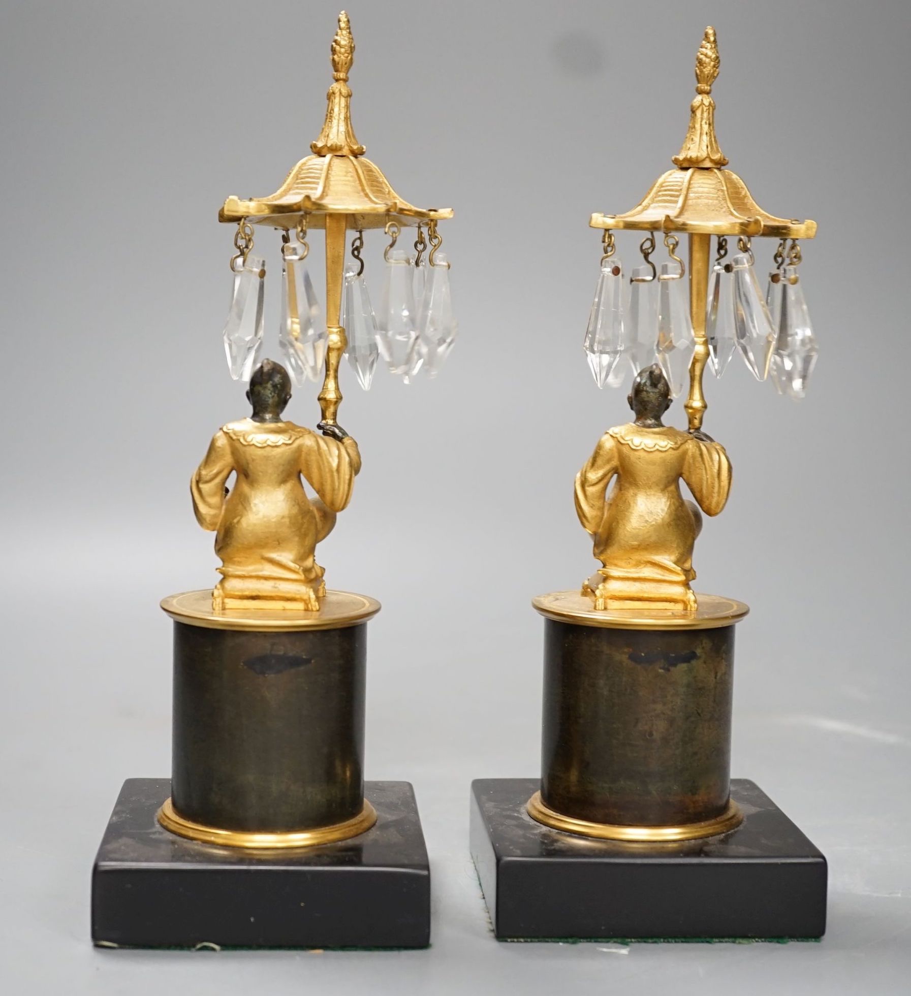 A pair of Louis XVI style bronze chinoiserie lustres depicted plinth seated gentleman bearing umbrella lustre drops - 23cm tall